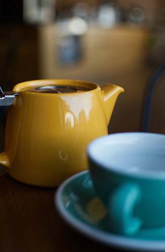 cup shallow focus photography of yellow ceramic teapot houston